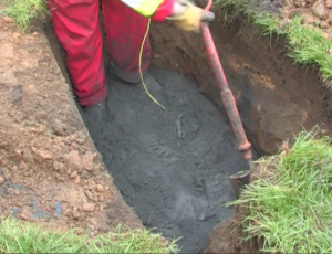 The roadside excavation for a broadband cabinet with 16mm wire earth ring encased in Conducrete, with Conducrete evenly spread