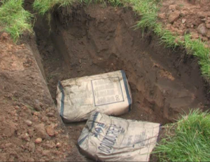 The roadside excavation for a broadband cabinet with two bags of Conducrete